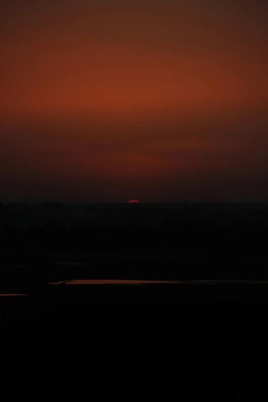 an airplane flying at dusk as the sun is just beginning to rise