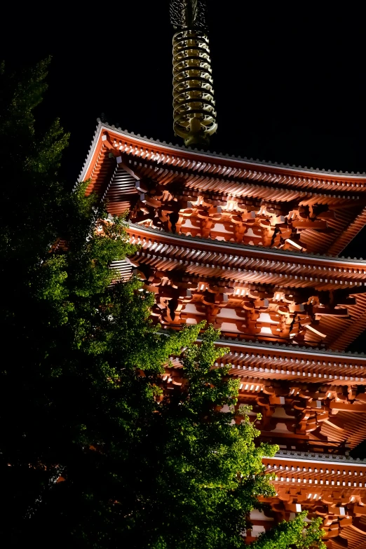 a lighted tower in the middle of the forest