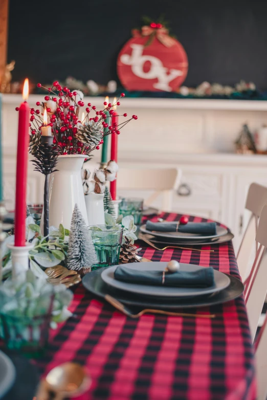 a table decorated with plates and place settings