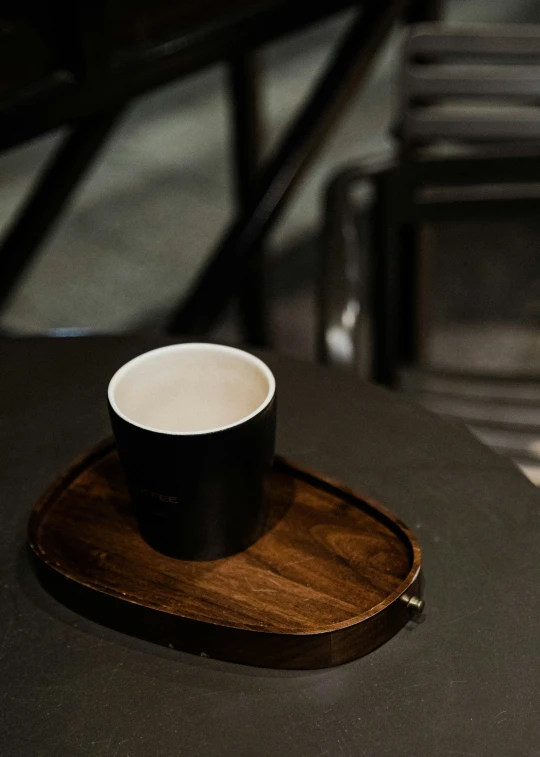 the drink on the small wooden tray is ready to be tasted