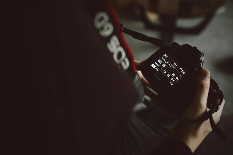 a person holding a phone in their hands and a pair of headphones out