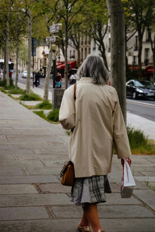 an old woman walking down the sidewalk