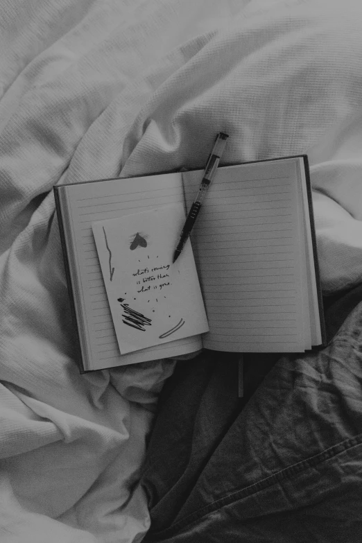 a book opened to lie on an unmade bed