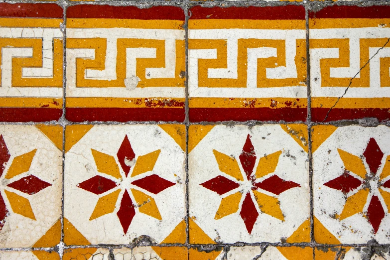 a very pretty colorful tile design on the side of a building