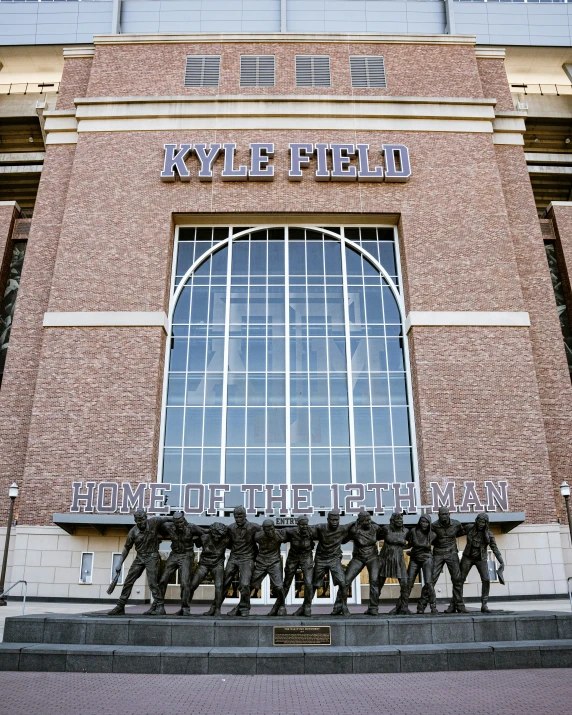 statue in front of large brick building with entrance