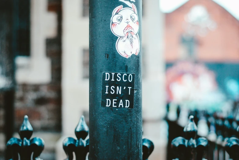 a sticker of a dead head is attached to a pole