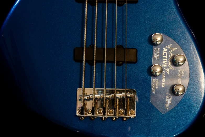 a blue guitar neck with strings and s
