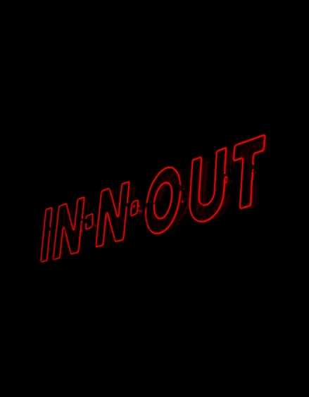 a red neon sign against a dark background