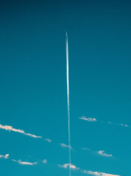 an airplane is flying through the sky and leaving a trail