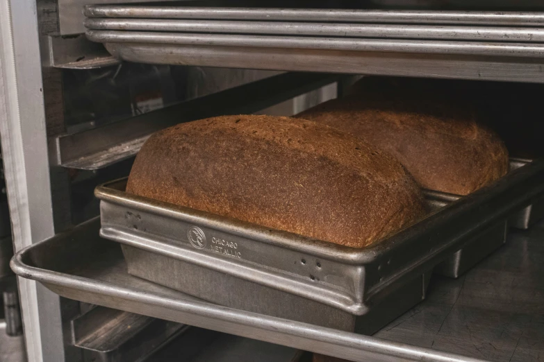 bread in an oven on top of aluminum trays