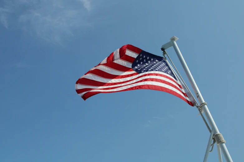 a very large american flag flying in the air