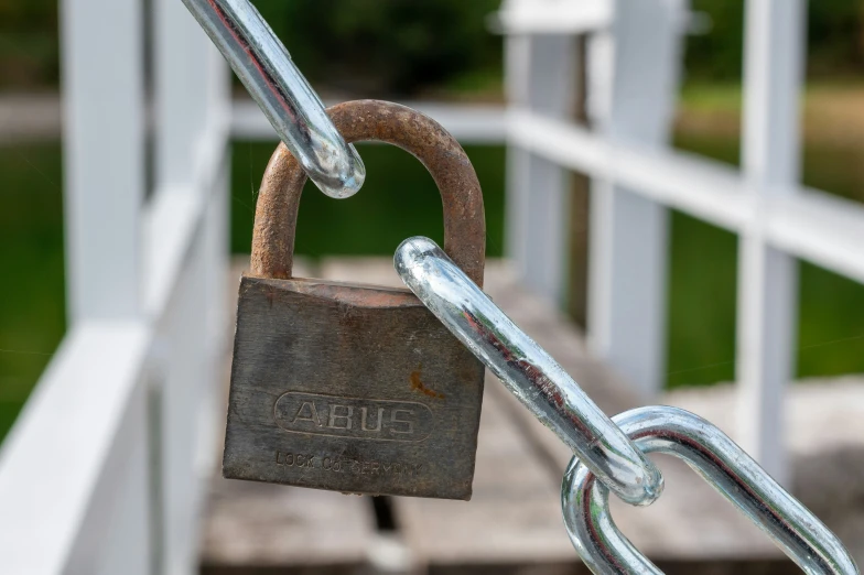 closeup of a padlock attached to a metal gate