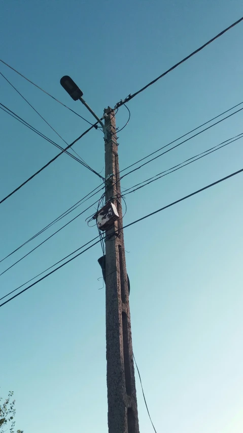 an electrical post has power lines across it