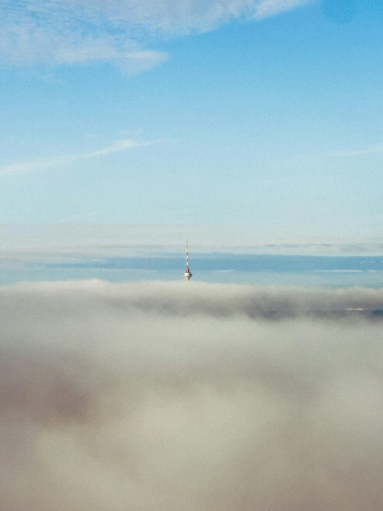 a very tall building near some clouds