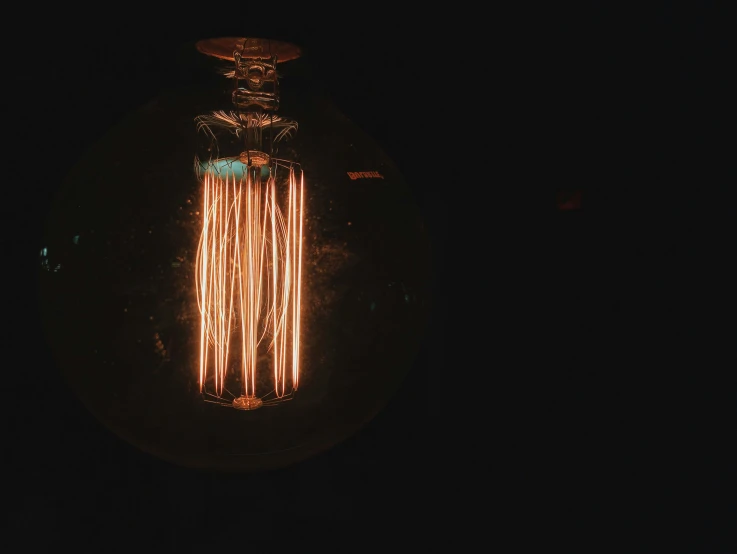 lit candles burning in a bottle on top of a table