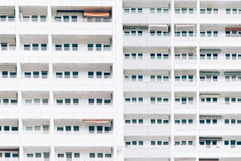 the side of a building, with windows and shutters on the outside