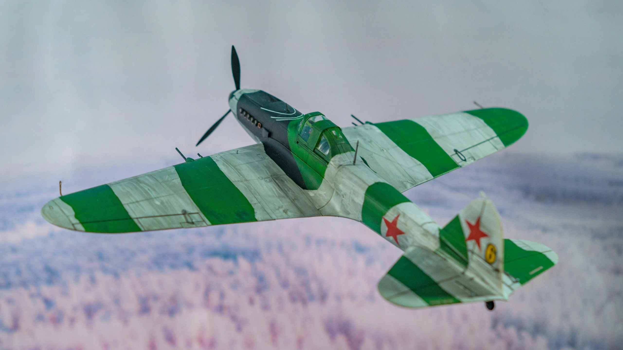 a green and white plane flying next to another plane