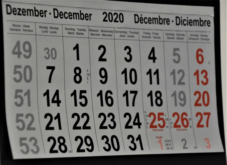 a small calendar is mounted on a wall