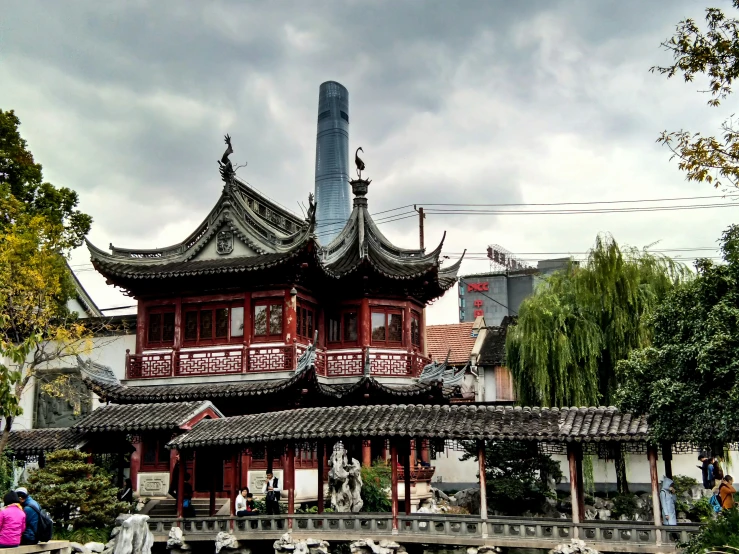 the pagoda is in the foreground as the building in the background houses several asian styled buildings