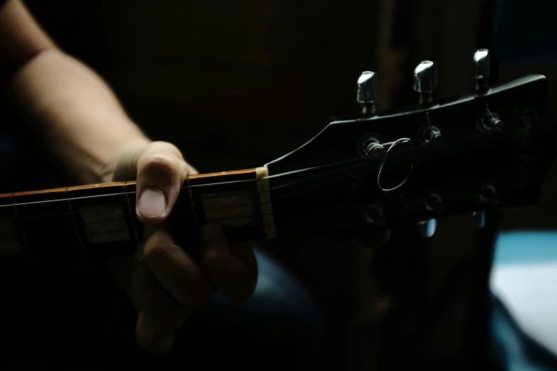 there is someone holding on to an old style guitar