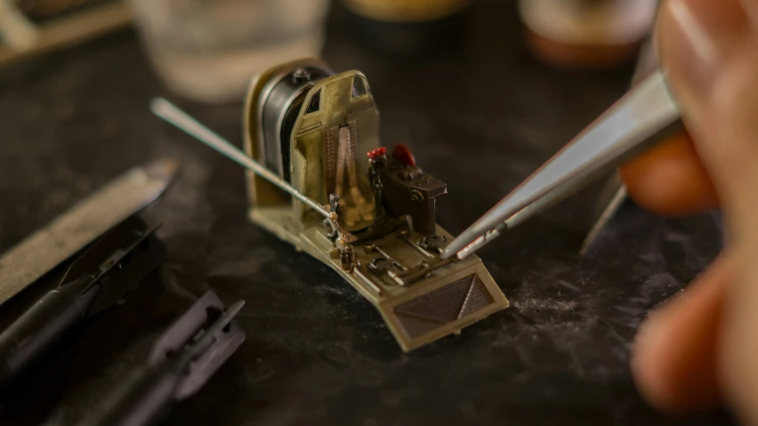 the clock is being made using tiny tools