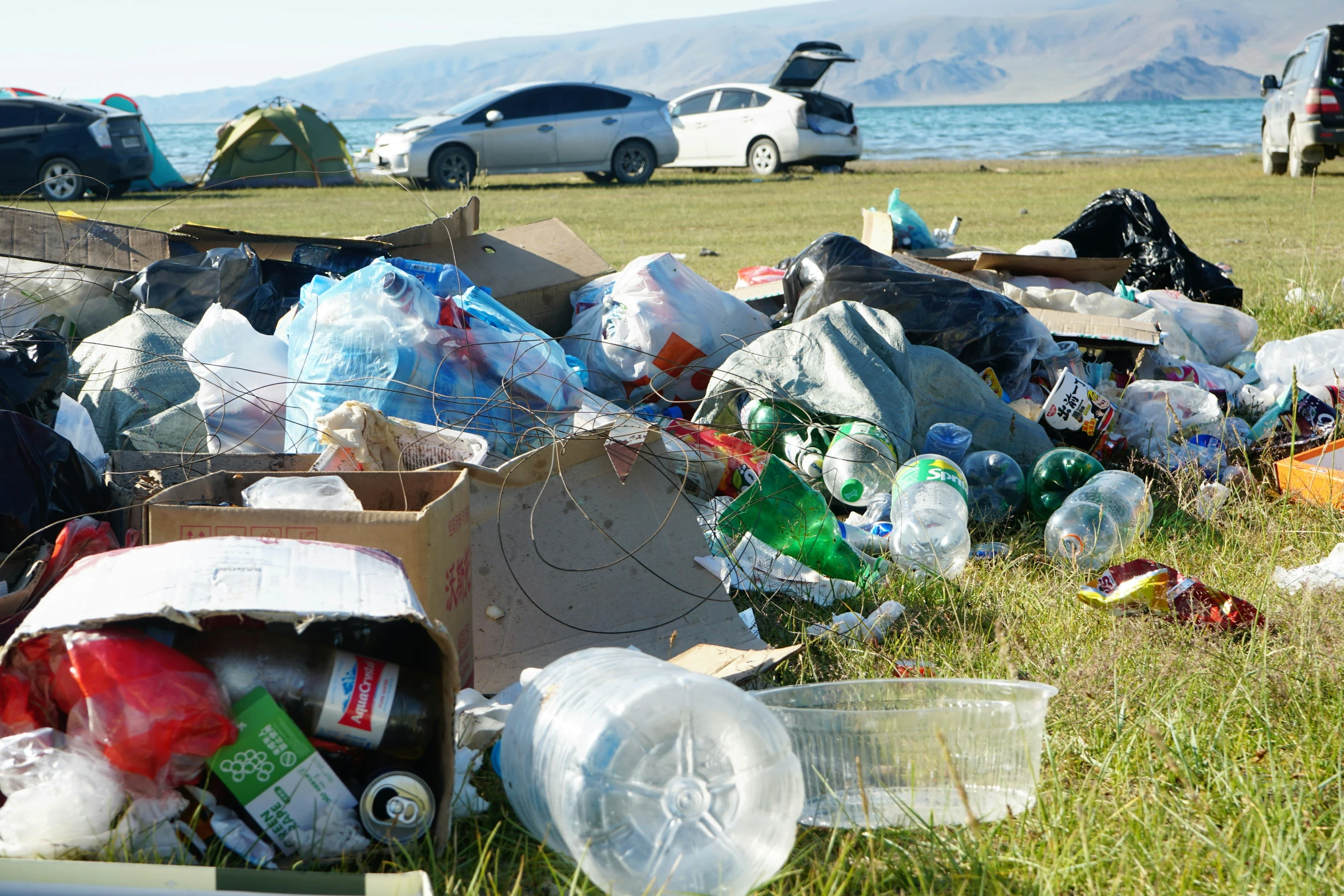 a large pile of trash sitting in the middle of a field