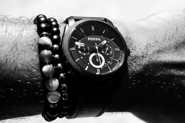 a black and white po of a wrist with a watch