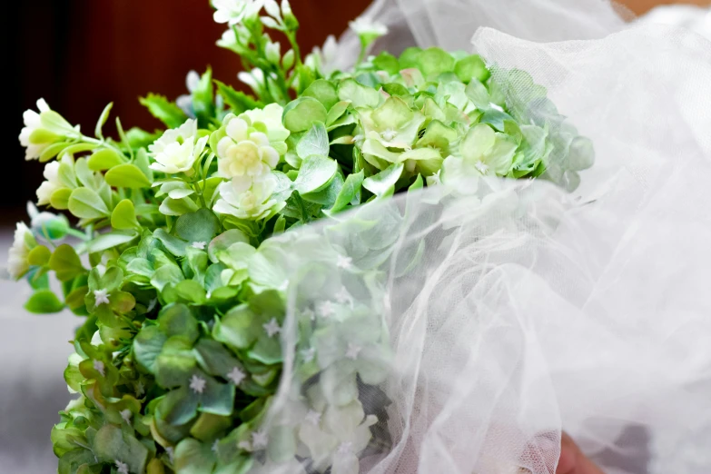 flowers are dd over an organ - gauze wrapped bouquet