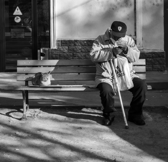 a man sitting on a bench outside of a building