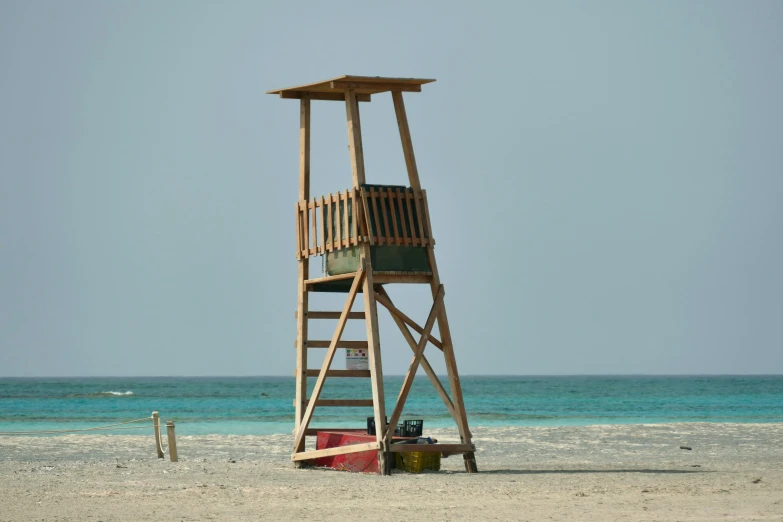 a lifeguard tower sitting at the end of the beach