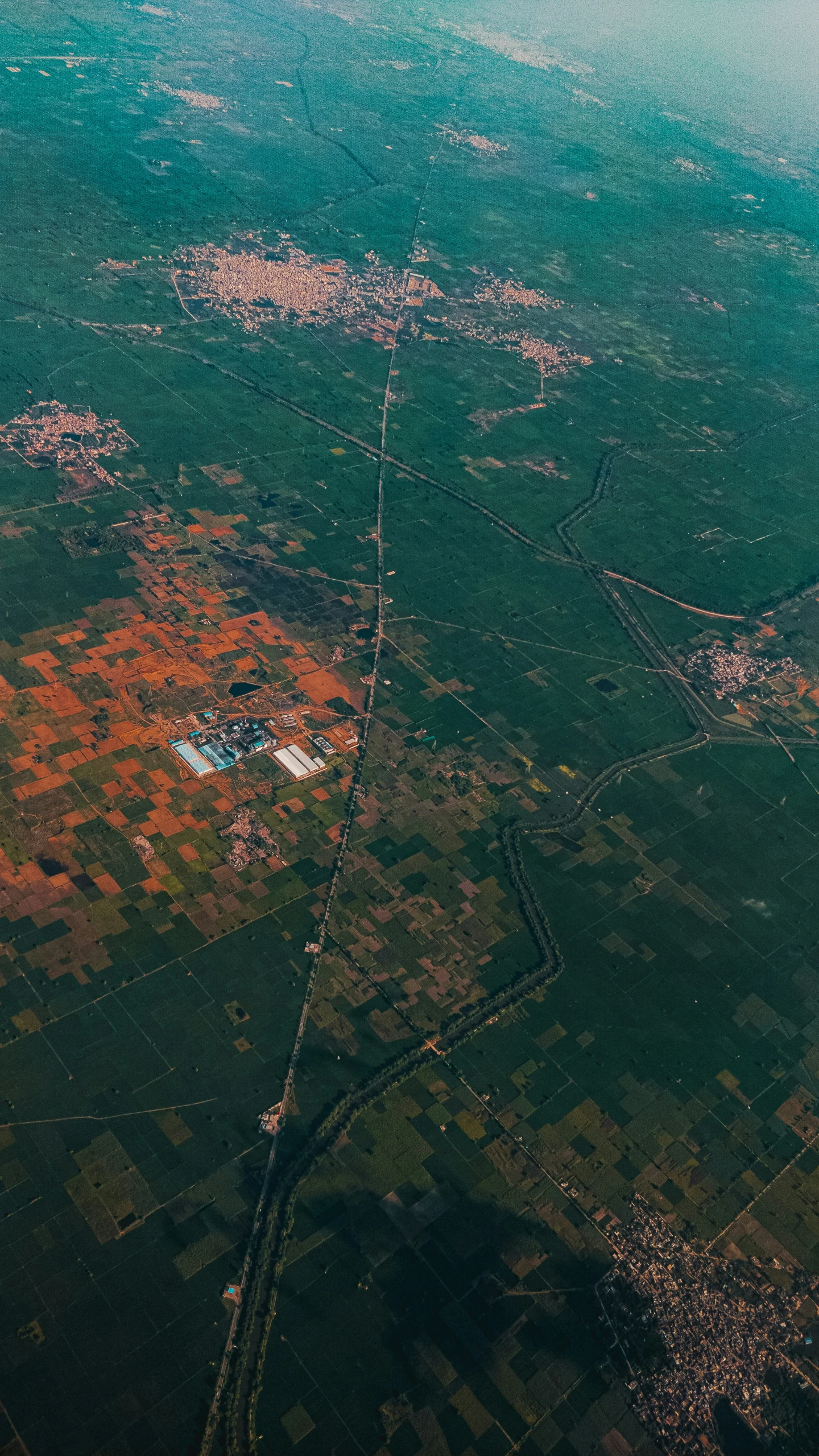 an aerial s of some green and brown fields