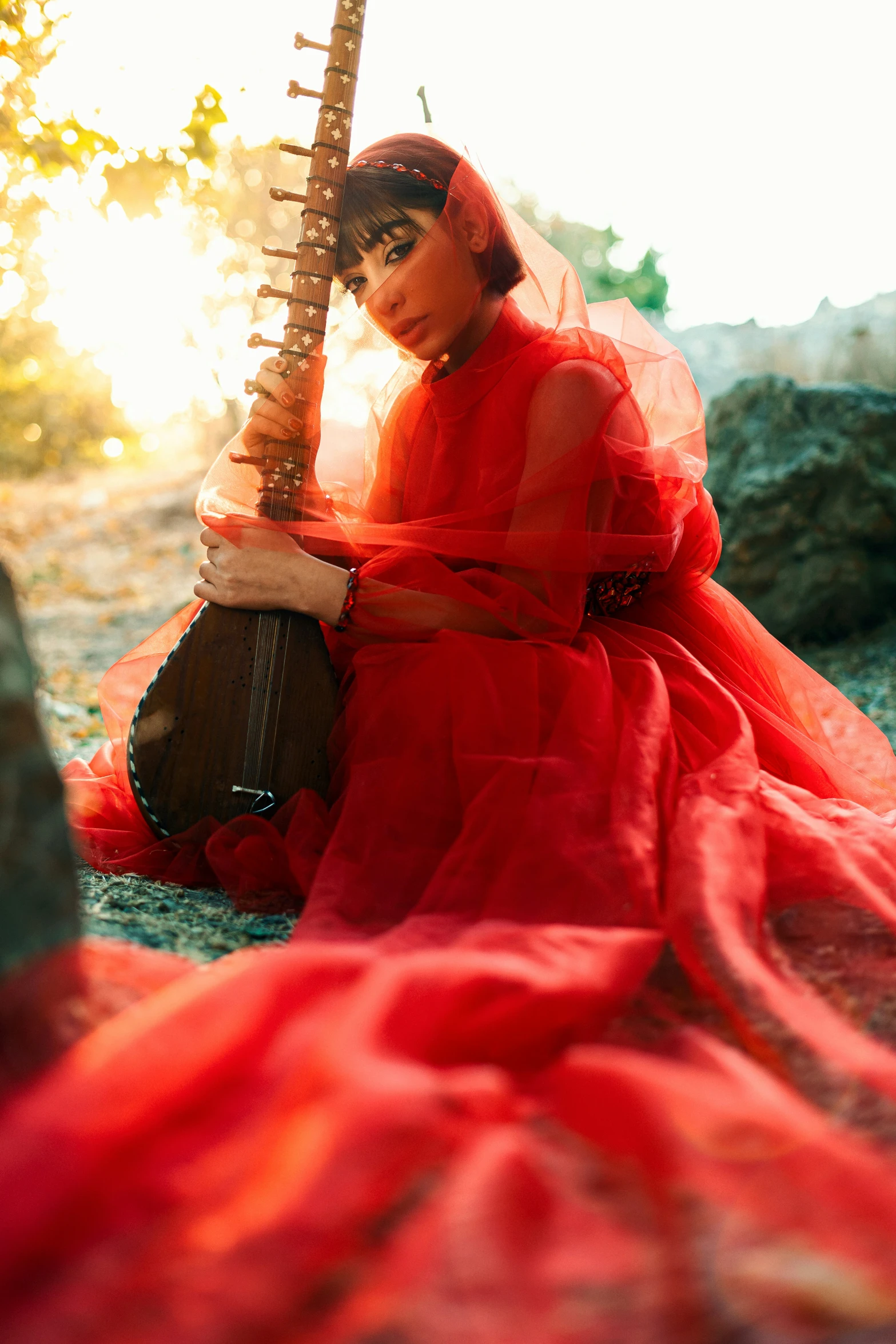 a woman is wearing a long red dress