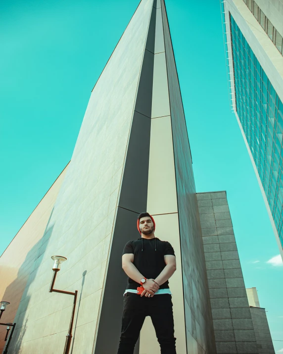 a man is standing near the tall buildings