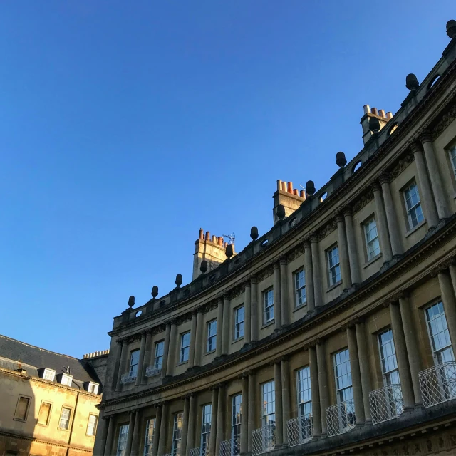 there is a large brown building with a clock on the top of it