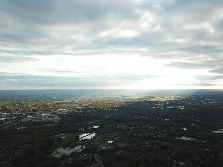 the clouds over the town reflect sunlight through