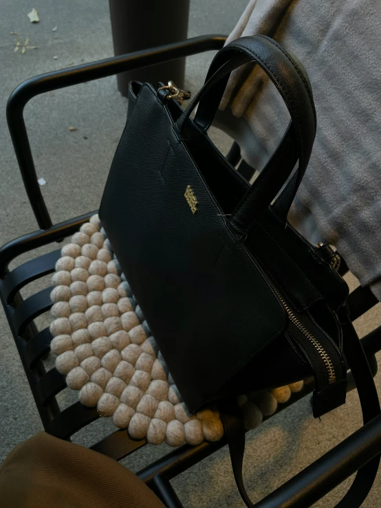 a purse and bag are sitting on top of a chair