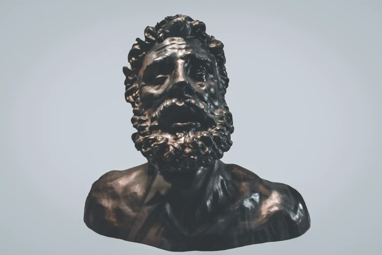 the head and torso of a bronze statue of jesus