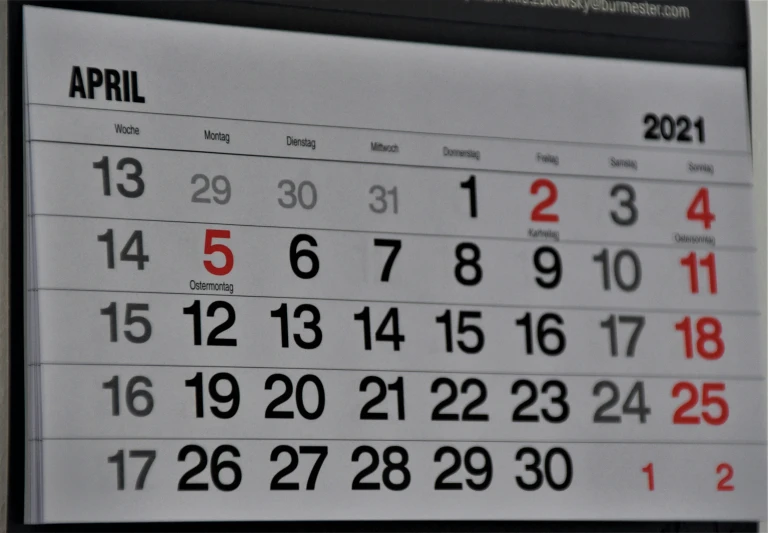 a very small calendar on a table with a pen and pencil