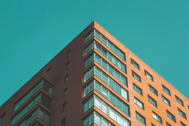 a tall brown building with a traffic light attached to it's side