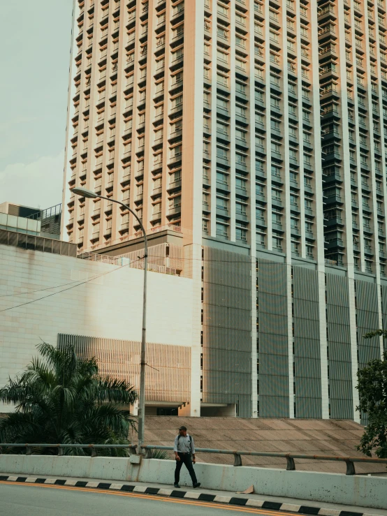 a person walking in the street near a building