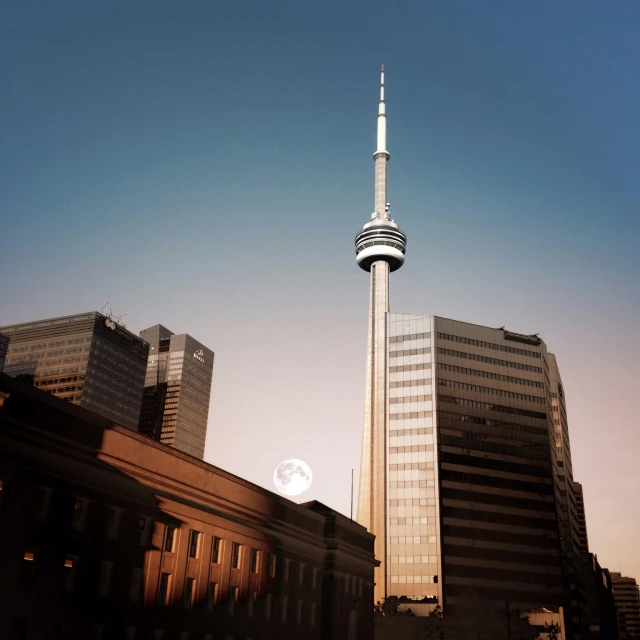 a tall building is towering above other buildings