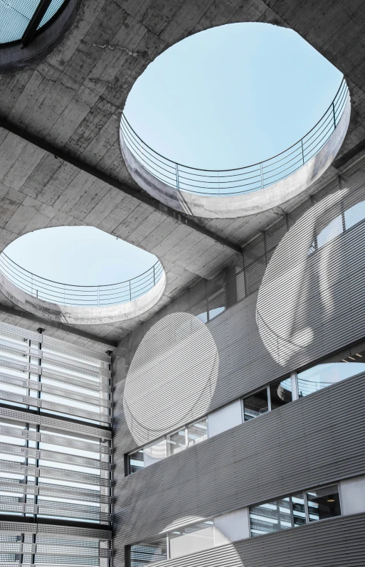 the ceiling has round glass panels with circular windows above it