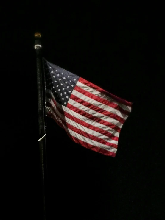 an american flag is visible in the dark