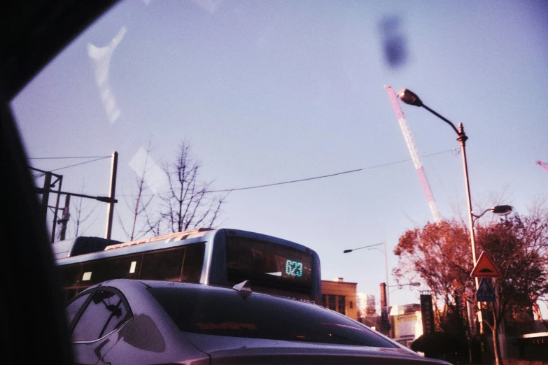 the view through a windshield of a car at street lights