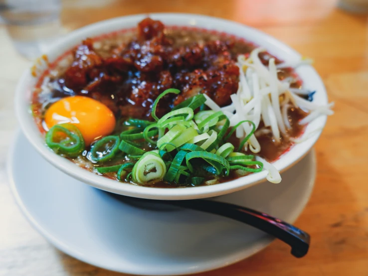 a bowl of soup with vegetables and eggs