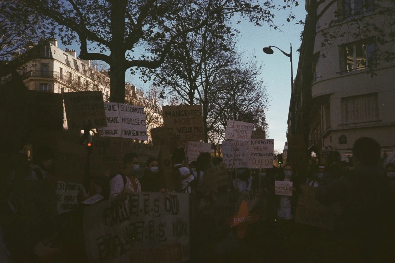 a large group of people in the street with protest signs