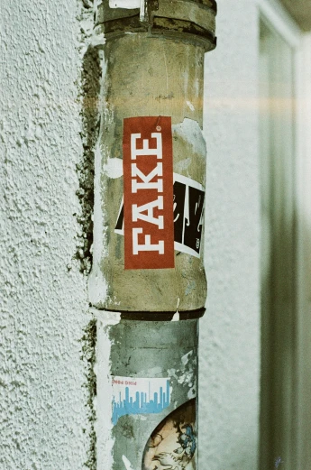 an old post with a sticker for tax on it