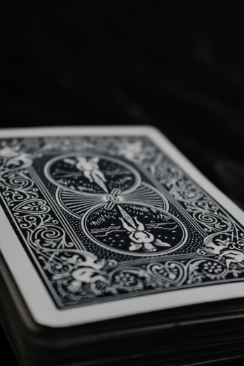 an ace playing card on a black table
