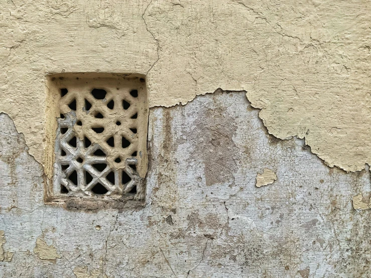 an old wall with some very strange holes