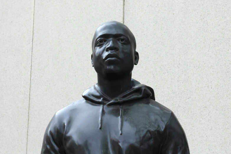 a statue in the shape of a man wearing a hoodie